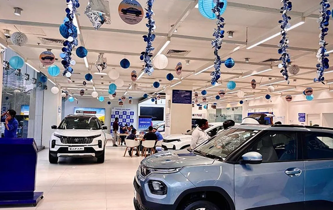 Tata passenger cars and electric vehicles displayed at a dealership during festive offers